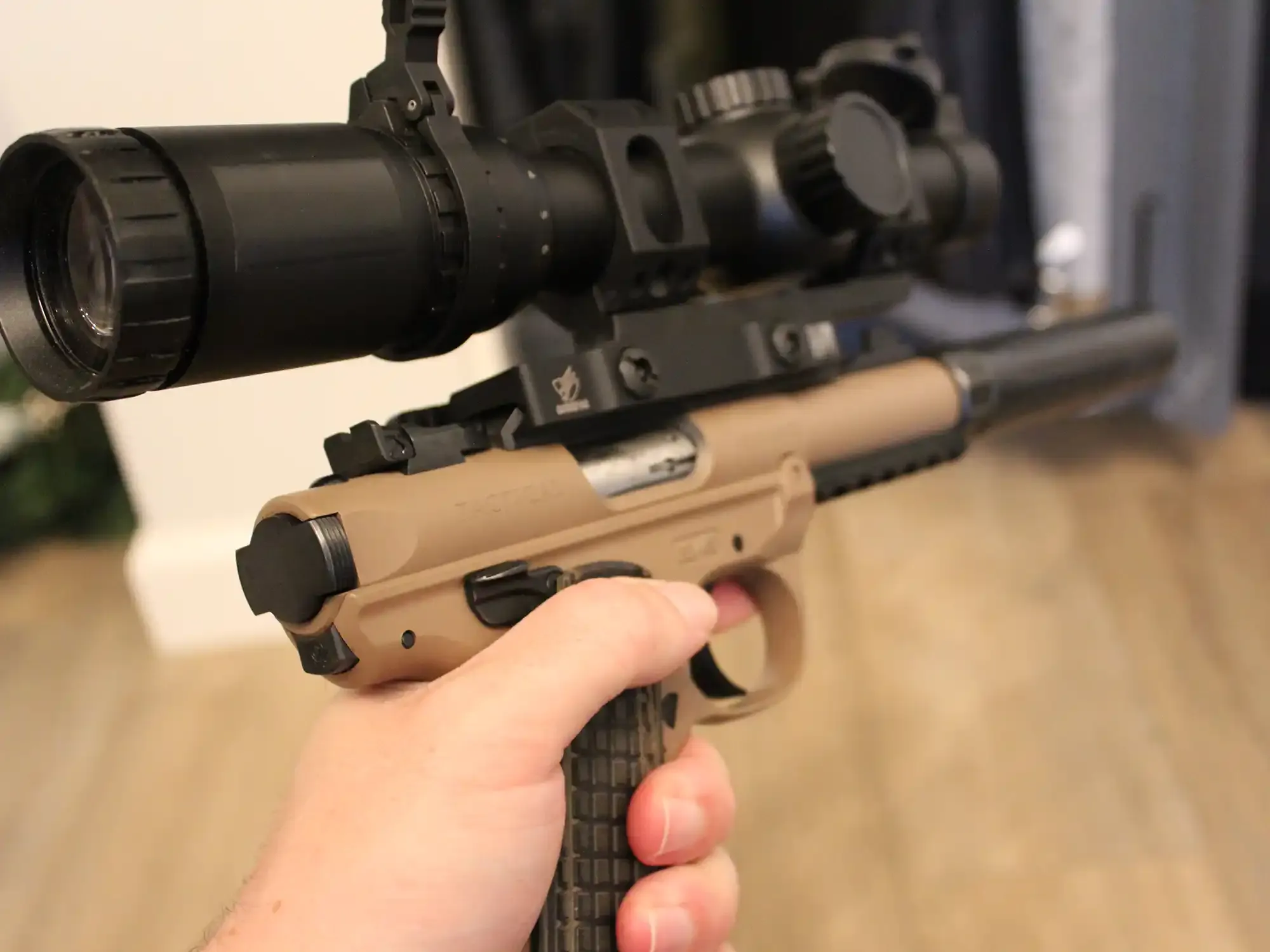 Ruger Mark IV 22 LR pistol with ridiculous attachments, scope, and suppressor